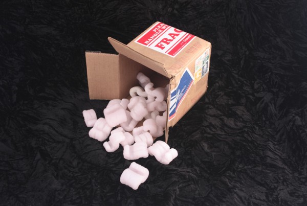 Cardboard box with pink cast glass packing peanuts