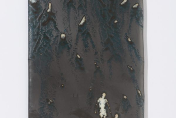 Metallic-looking glass panel with small figures of a child and father holding hands